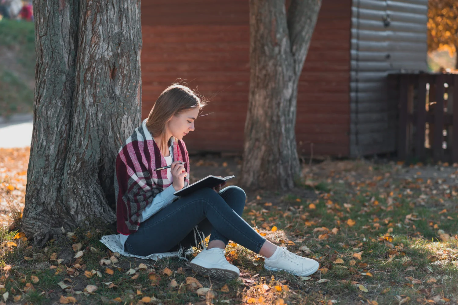 girl sitting by a tree girl sitting by a tree